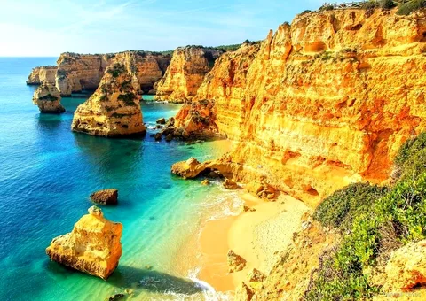 Group walking the coastal trail on the Benagil Caves full-day tour from Faro
